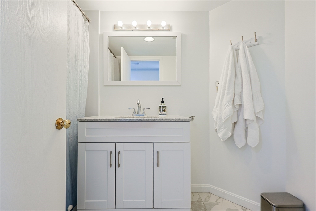 276 Trailside Way, Unit 276 Ashland, MA 01721 - Photo 21 of 32 a bathroom with a sink vanity and a mirror