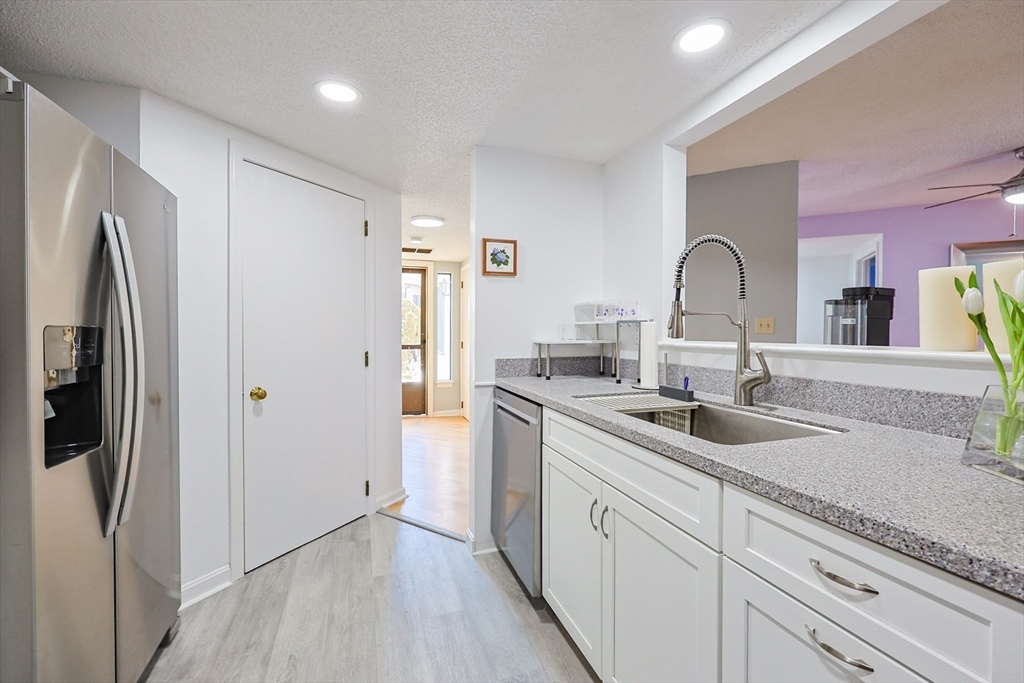 276 Trailside Way, Unit 276 Ashland, MA 01721 - Photo 6 of 32 a kitchen with stainless steel appliances granite countertop a refrigerator and a sink