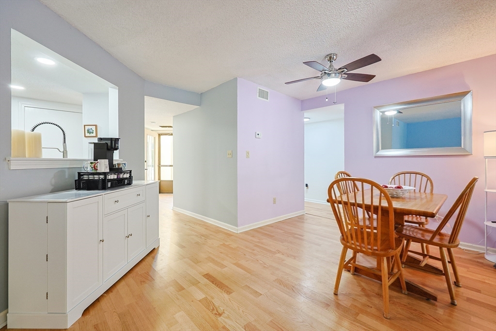 276 Trailside Way, Unit 276 Ashland, MA 01721 - Photo 7 of 32 a view of dining room a window and wooden floor