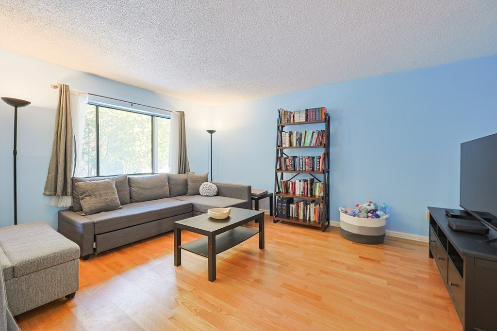 276 Trailside Way, Unit 276 Ashland, MA 01721 - Photo 8 of 32 a living room with furniture and a book shelf