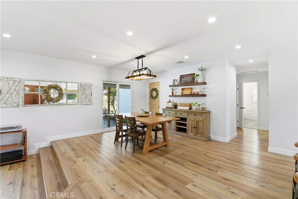 10560 Limerick Avenue Chatsworth, CA 91311 - Photo 15 of 43 a view of a dining room with furniture and wooden floor