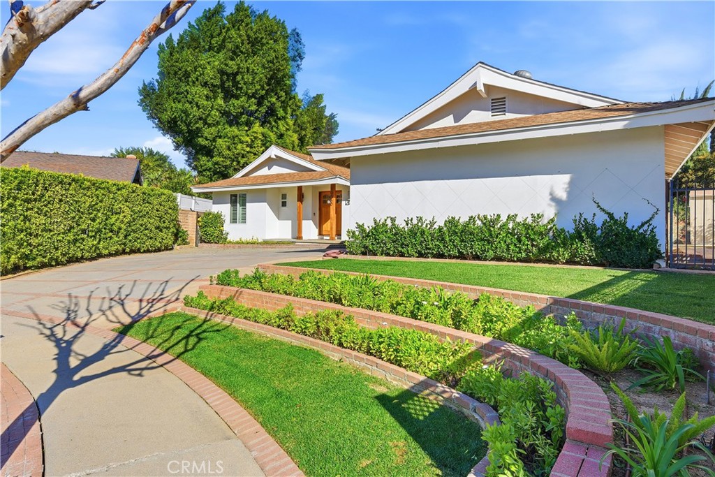 10560 Limerick Avenue Chatsworth, CA 91311 - Photo 2 of 43 a front view of a house with a yard
