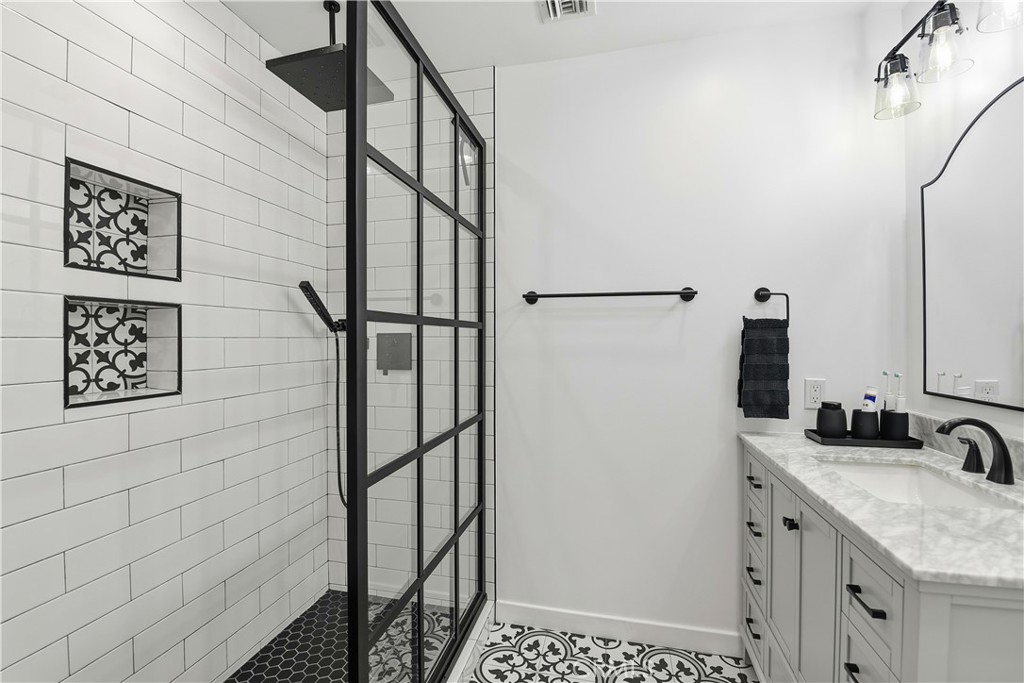 10560 Limerick Avenue Chatsworth, CA 91311 - Photo 28 of 43 a bathroom with a sink and a mirror