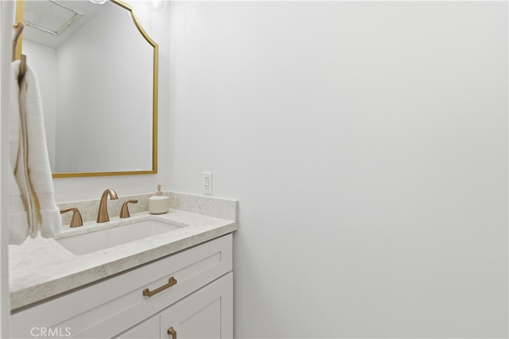 10560 Limerick Avenue Chatsworth, CA 91311 - Photo 29 of 43 a bathroom with a sink and a mirror