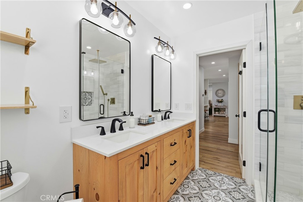 10560 Limerick Avenue Chatsworth, CA 91311 - Photo 31 of 43 a bathroom with a double vanity sink mirror double vanity and shower