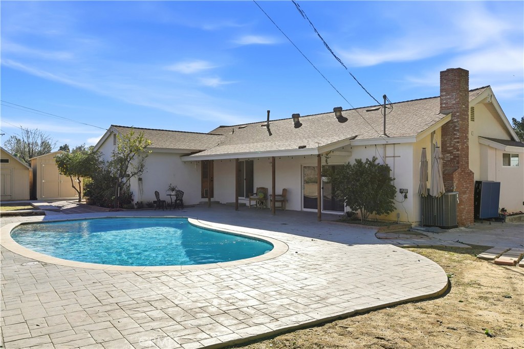 10560 Limerick Avenue Chatsworth, CA 91311 - Photo 35 of 43 a view of a house with swimming pool and sitting area