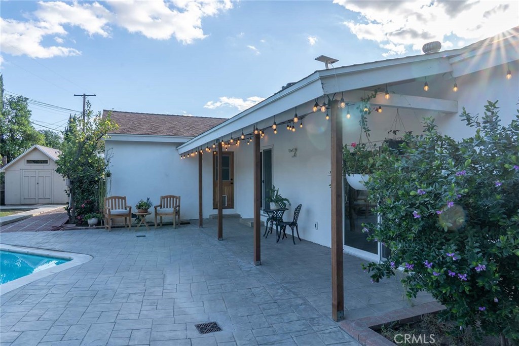 10560 Limerick Avenue Chatsworth, CA 91311 - Photo 40 of 43 a view of a patio with table and chairs and potted plants