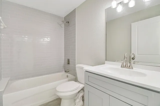 a bathroom with a sink a toilet and bathtub