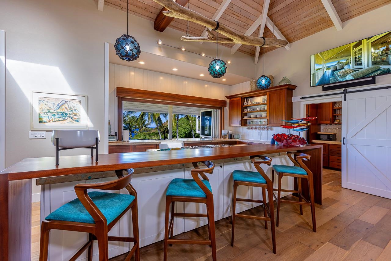 555 North Holokai Road Haiku, HI 96708 - Photo 9 of 50 The gourmet kitchen boasts a retractable glass window pass-thru to the ocean-side lanai
