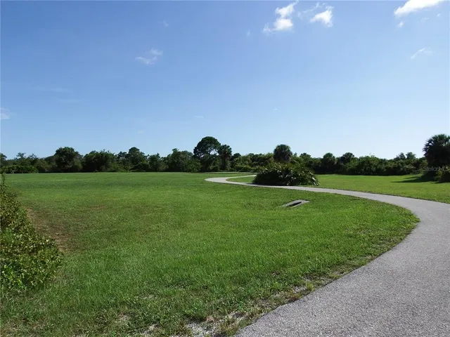 a front view of a house with yard garage and outdoor seating