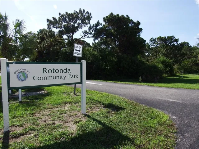a view of swimming pool with a yard and potted plants