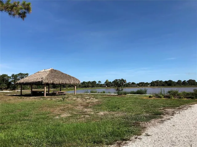 a view of a lake and yard in the back