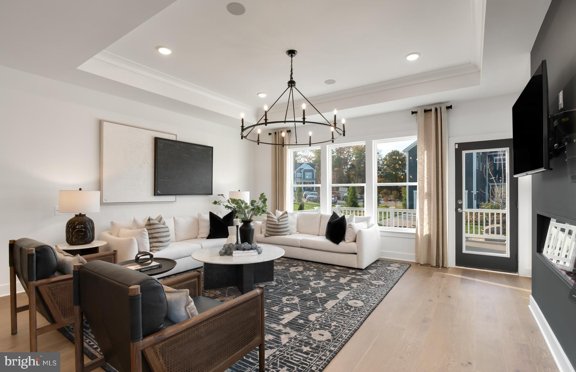 18278 Cresswell Rst Lane Leesburg, VA 20176 - Photo 19 of 63 a living room with furniture a flat screen tv and a large window
