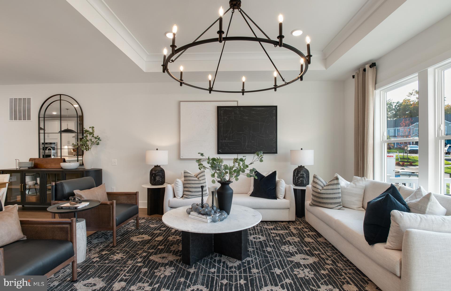 18278 Cresswell Rst Lane Leesburg, VA 20176 - Photo 21 of 63 a living room with furniture a chandelier and a flat screen tv