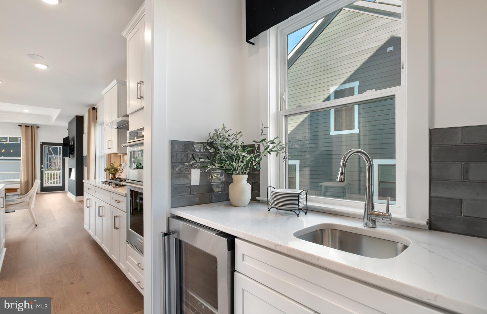 18278 Cresswell Rst Lane Leesburg, VA 20176 - Photo 9 of 63 a kitchen with a sink and refrigerator