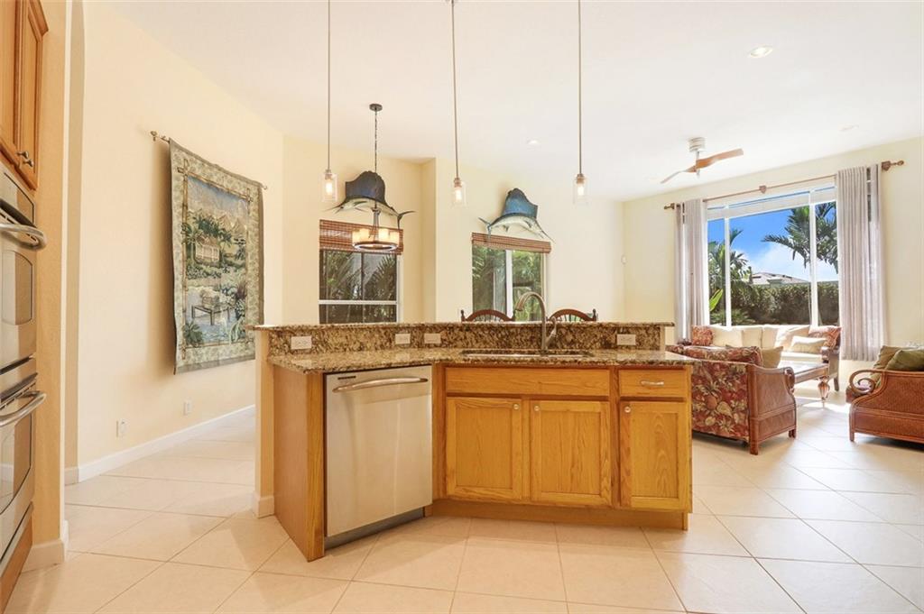 767 Southwest River Bend Circle Stuart, FL 34997 - Photo 12 of 36 a kitchen with stainless steel appliances granite countertop a stove a sink and a microwave