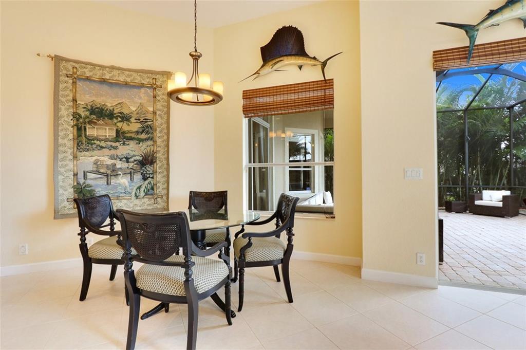 767 Southwest River Bend Circle Stuart, FL 34997 - Photo 13 of 36 a view of a dining room with furniture and wooden floor