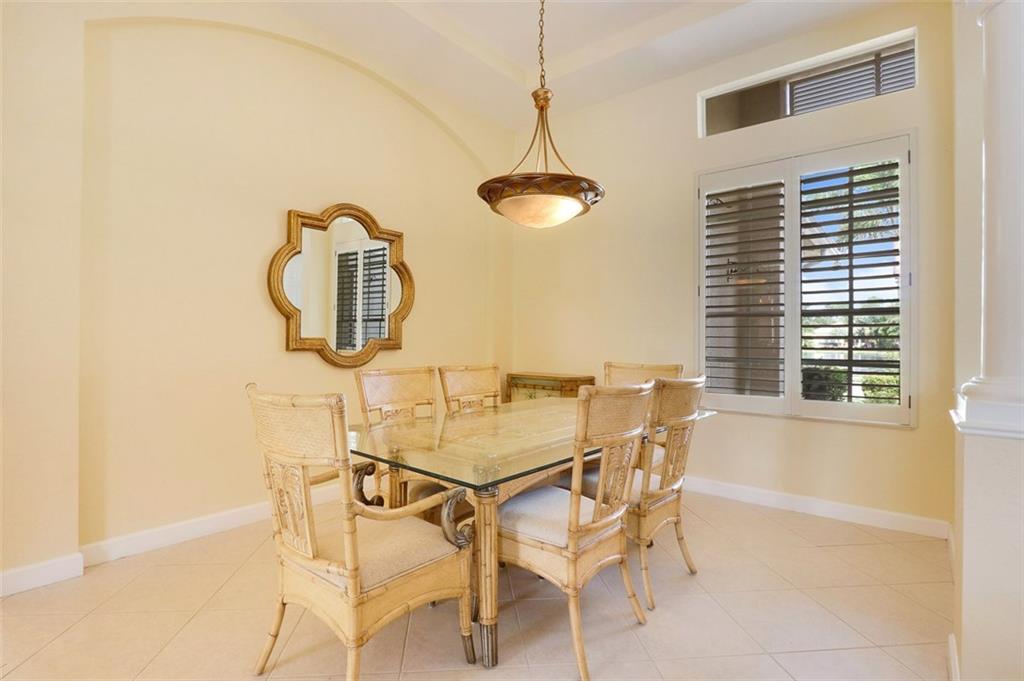 767 Southwest River Bend Circle Stuart, FL 34997 - Photo 17 of 36 a dining room with chandelier fan and wooden floor