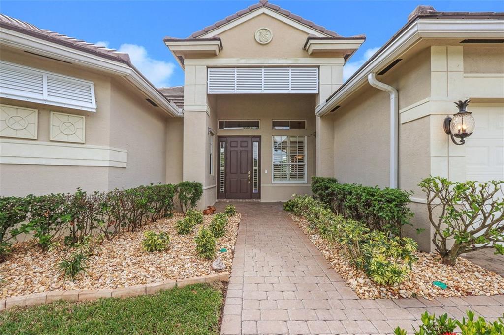 767 Southwest River Bend Circle Stuart, FL 34997 - Photo 19 of 36 a front view of a house with garden