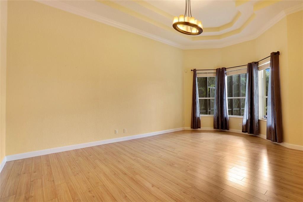767 Southwest River Bend Circle Stuart, FL 34997 - Photo 21 of 36 a view of a room with wooden floor and large window