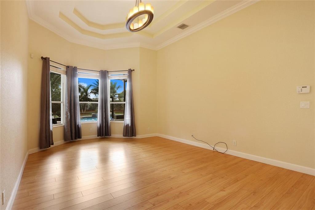 767 Southwest River Bend Circle Stuart, FL 34997 - Photo 22 of 36 a view of a room with wooden floor and window
