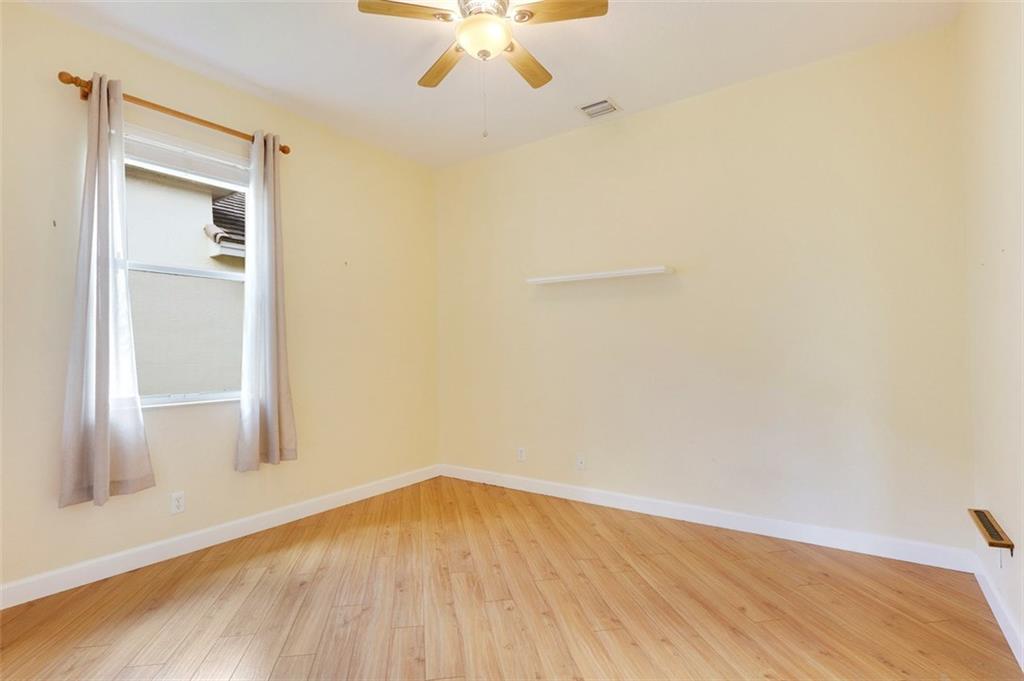 767 Southwest River Bend Circle Stuart, FL 34997 - Photo 26 of 36 a view of empty room with wooden floor and fan