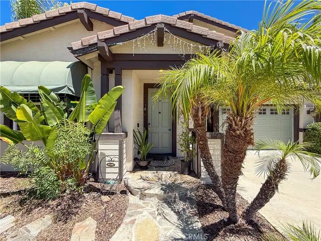 a view of a house with potted plants