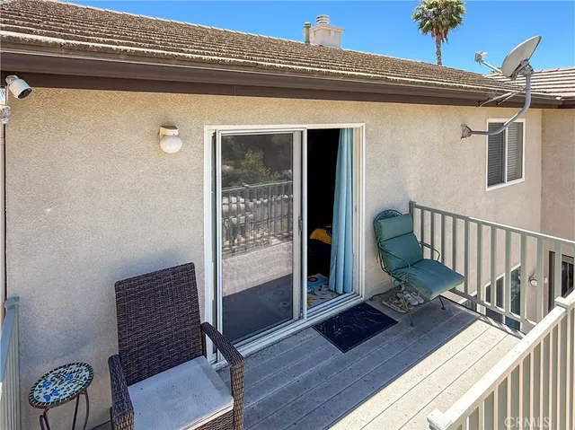 a view of a hallway with wooden floor and furniture
