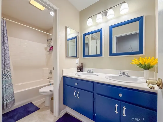 a bathroom with a sink vanity tub and toilet