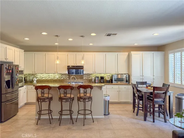 a kitchen with lots of counter top space and appliances
