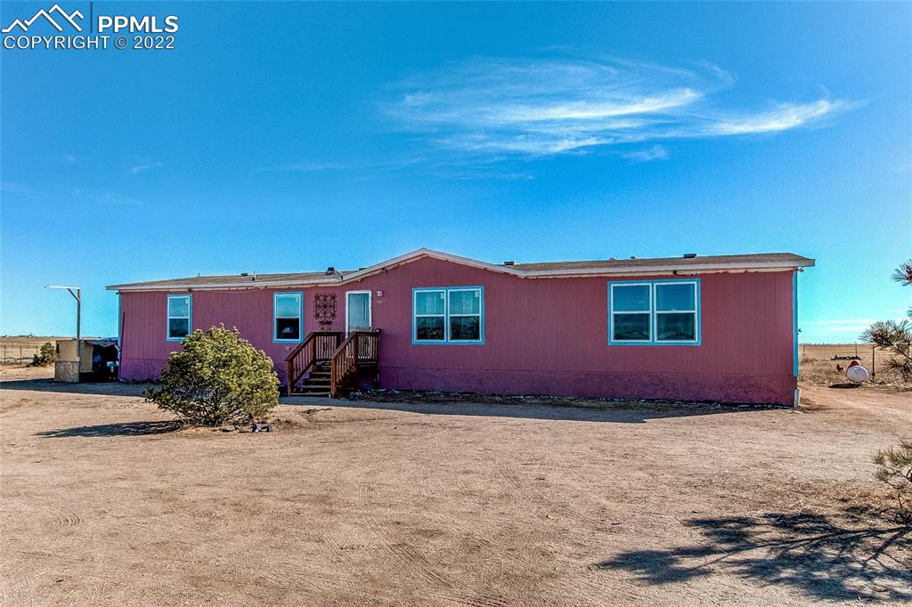5955 Mulberry Road Calhan, CO 80808 - Photo 1 of 25 a front view of a house with a yard