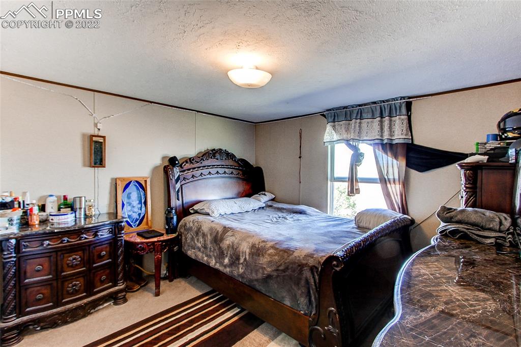 5955 Mulberry Road Calhan, CO 80808 - Photo 17 of 25 a bedroom with bed and a window