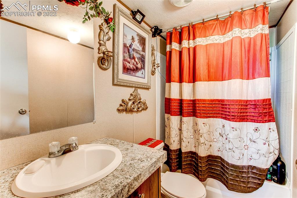 5955 Mulberry Road Calhan, CO 80808 - Photo 19 of 25 a bathroom with a sink and a mirror
