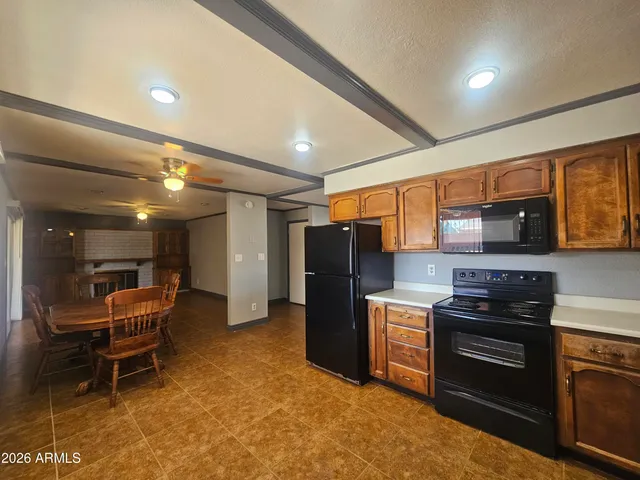 a kitchen with stainless steel appliances kitchen island granite countertop a stove and a refrigerator