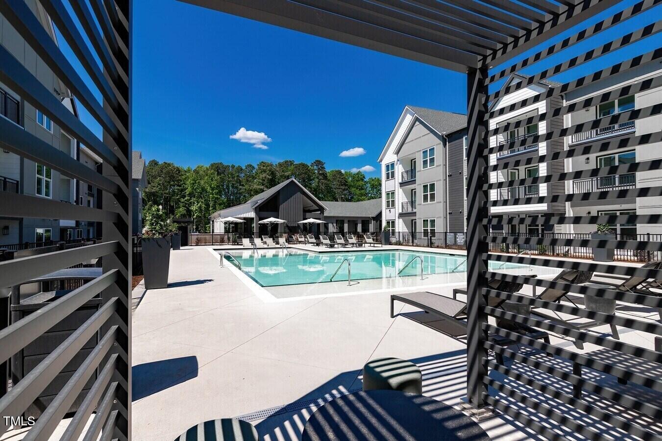 821 Hanbury Way, Unit A1 1 Raleigh, NC 27607 - Photo 32 of 43 a view of a patio with table and chairs with wooden floor and fence