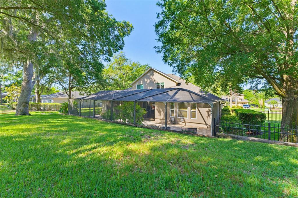 62 Camelot Ridge Drive Brandon, FL 33511 - Photo 64 of 71 a view of a house with a big yard potted plants and large tree