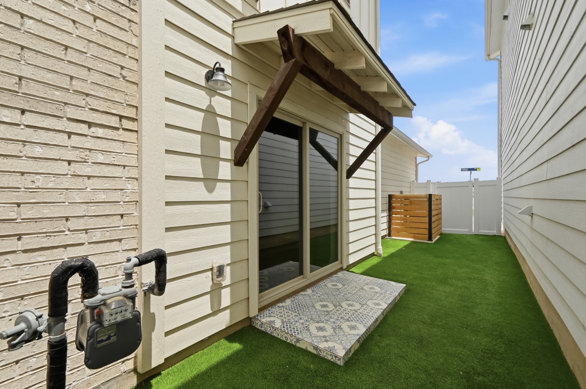8201 Frida Bend Austin, TX 78744 - Photo 28 of 29 A private, low-maintenance yard offers convenient access to the interior via sliding doors.