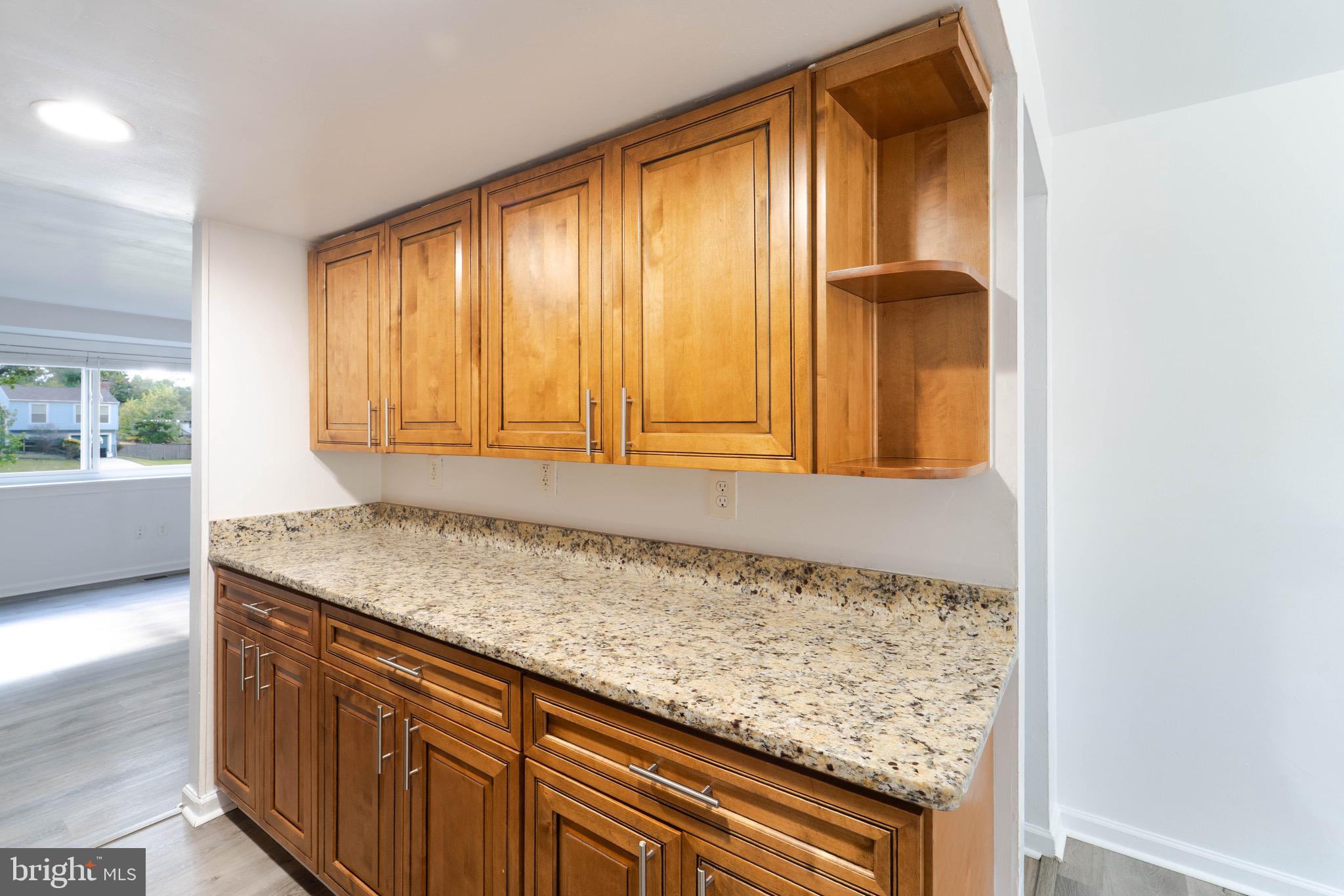 9318 Matador Road Columbia, MD 21045 - Photo 12 of 32 a bathroom with a granite countertop sink and a large mirror