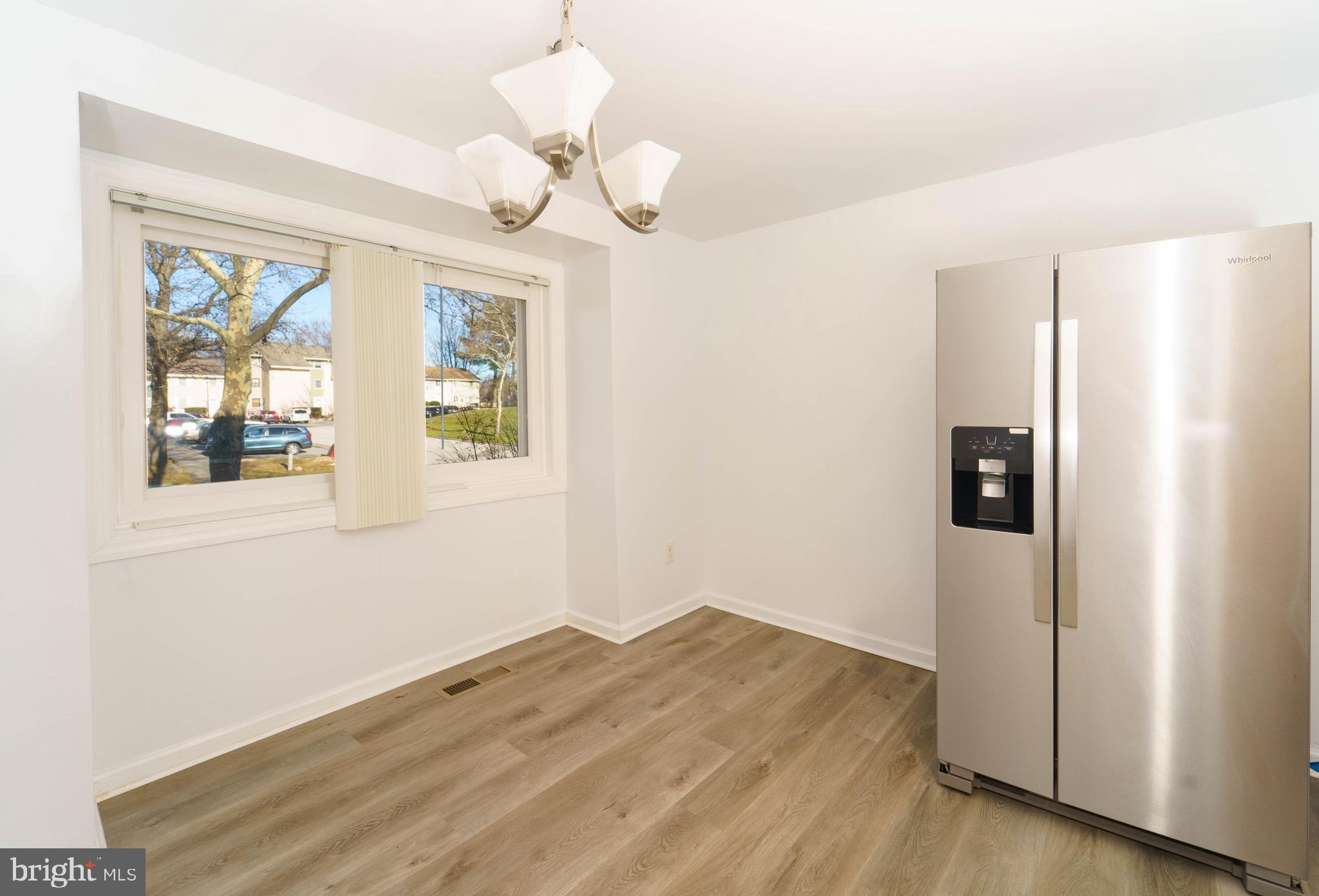 9318 Matador Road Columbia, MD 21045 - Photo 13 of 32 a view of a bedroom with wooden floor and windows