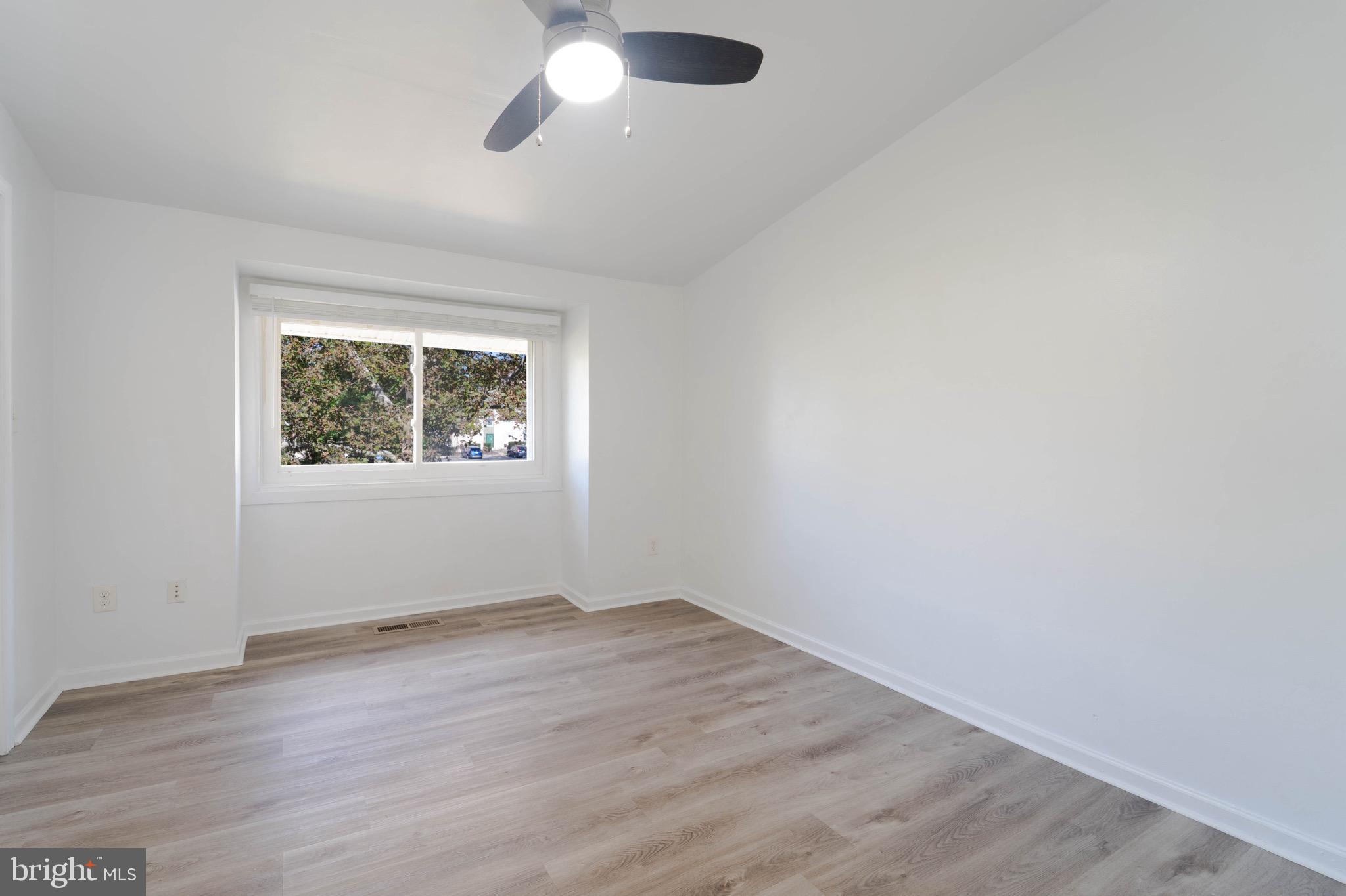 9318 Matador Road Columbia, MD 21045 - Photo 28 of 32 an empty room with wooden floor and windows