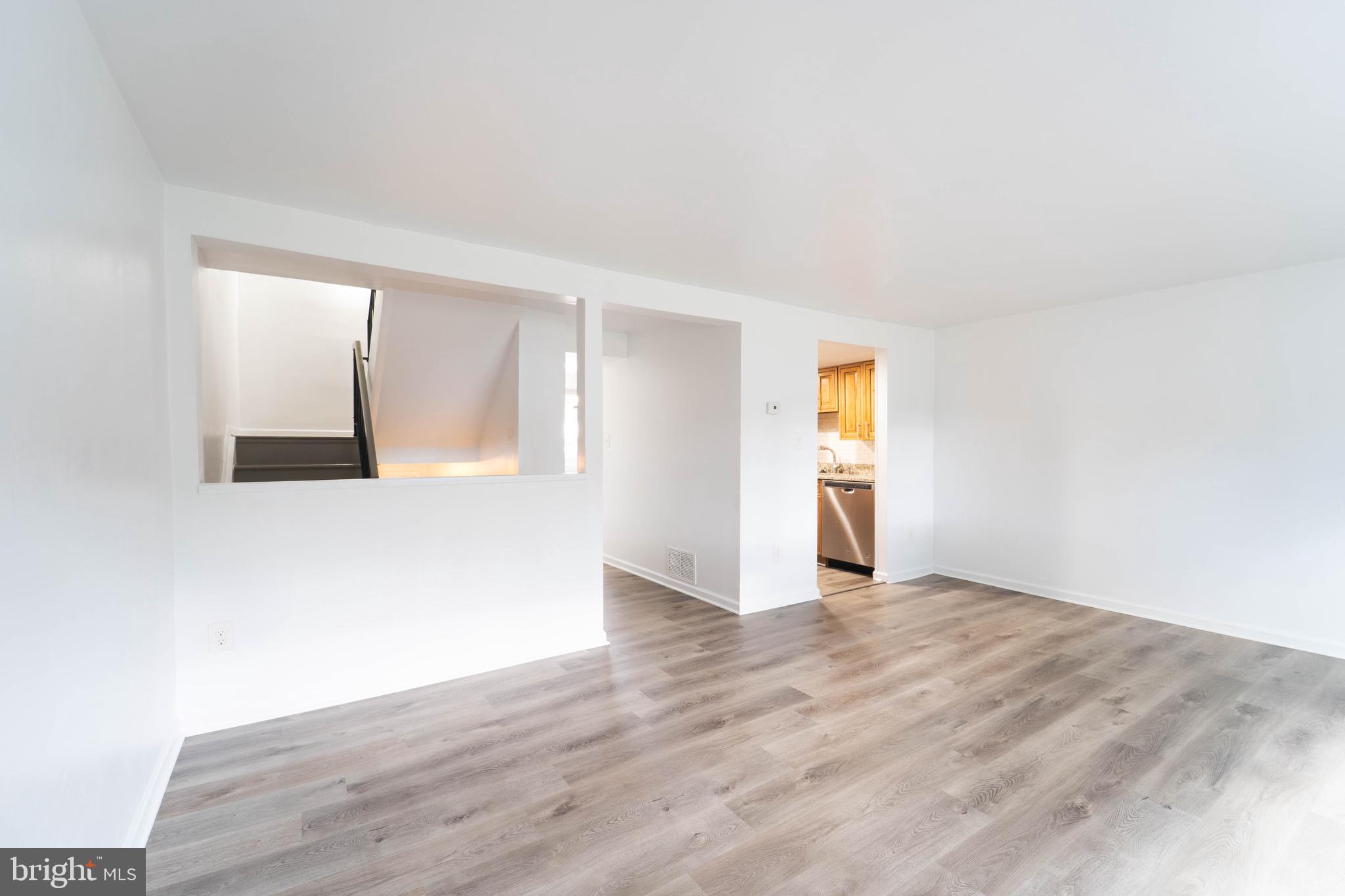 9318 Matador Road Columbia, MD 21045 - Photo 5 of 32 a view of an empty room with wooden floor and a window
