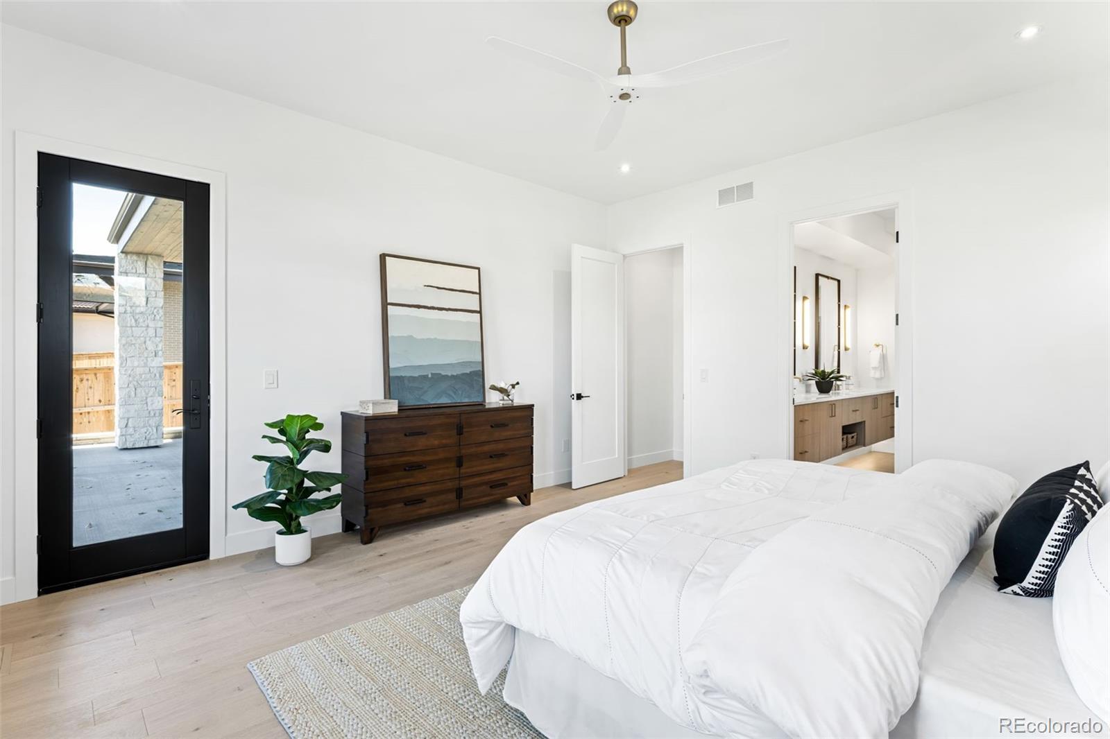 4645 Highline Place Denver, CO 80222 - Photo 27 of 48 a bedroom with a bed and wooden floor
