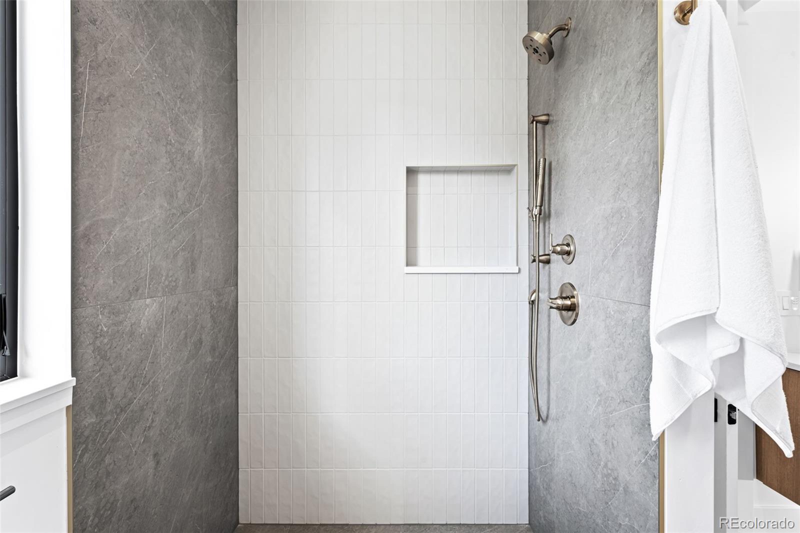 4645 Highline Place Denver, CO 80222 - Photo 30 of 48 a bathroom with a glass shower door