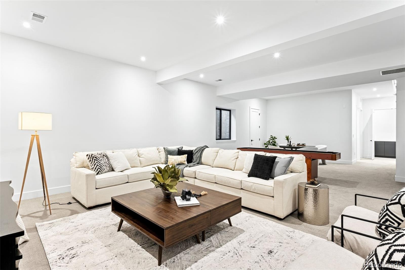 4645 Highline Place Denver, CO 80222 - Photo 35 of 48 a living room with furniture a rug and a lamp
