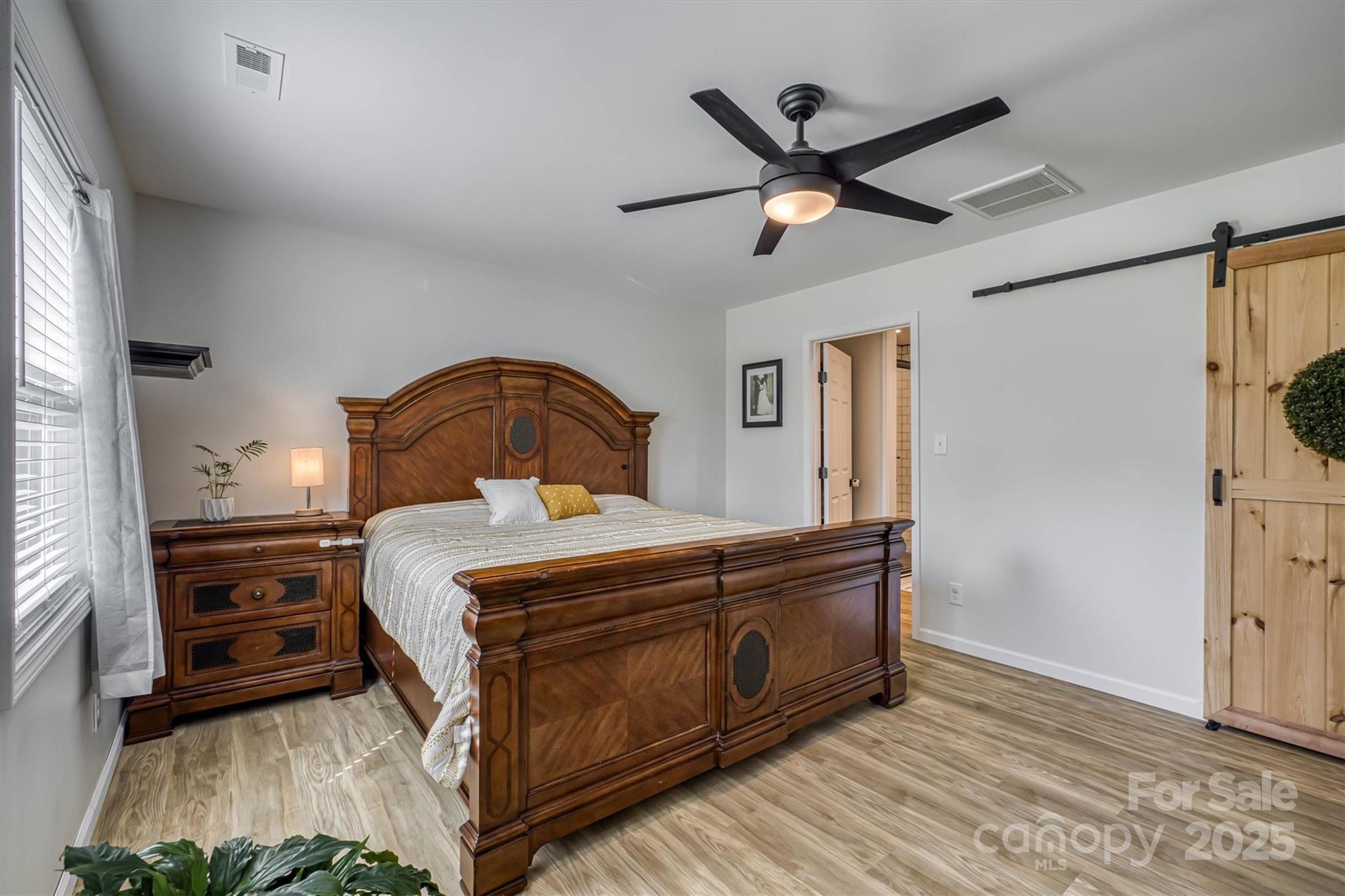 1173 Coffey Road Morganton, NC 28655 - Photo 11 of 26 a bedroom with a bed and a ceiling fan