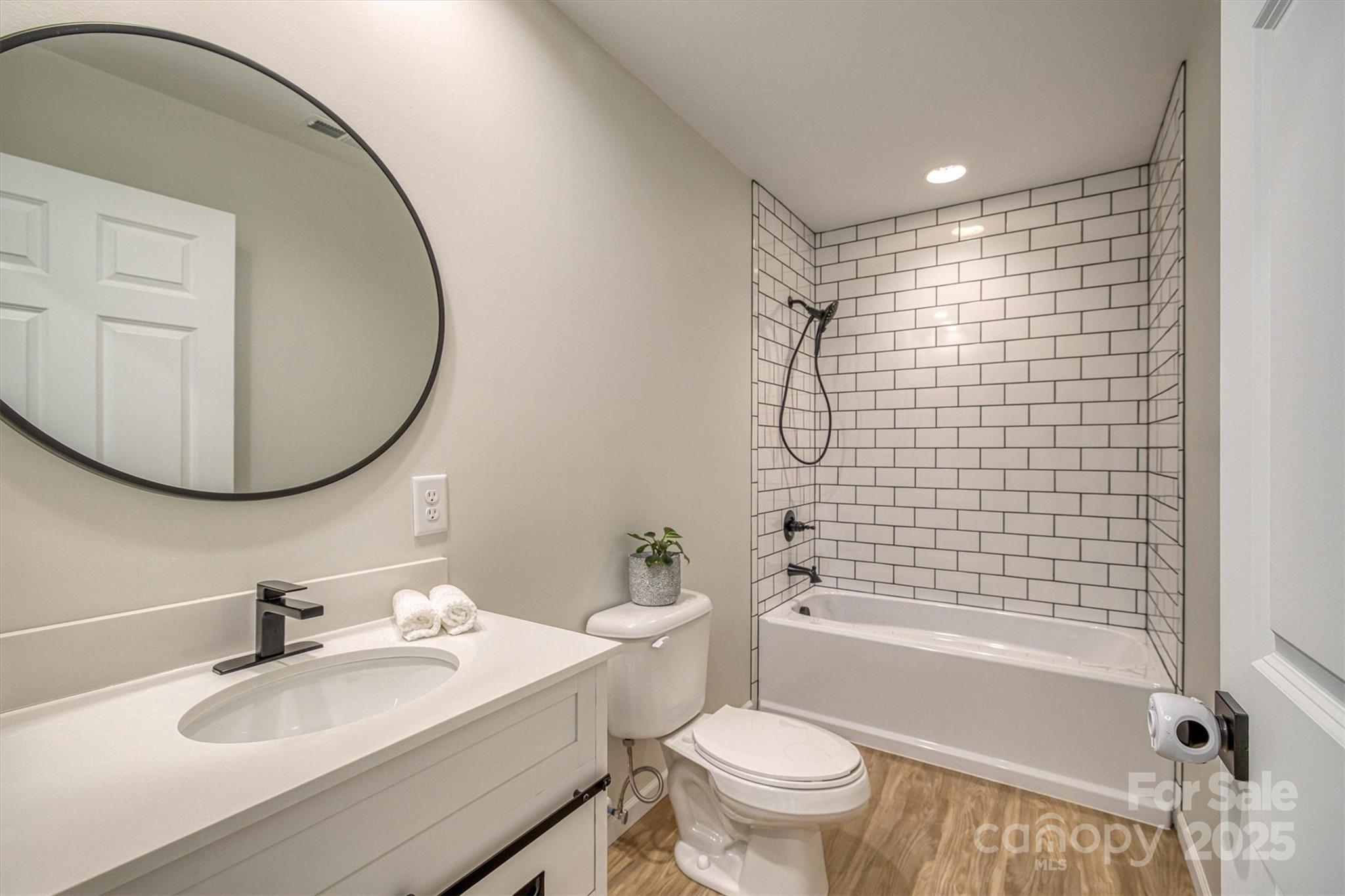 1173 Coffey Road Morganton, NC 28655 - Photo 16 of 26 a bathroom with a sink toilet and shower