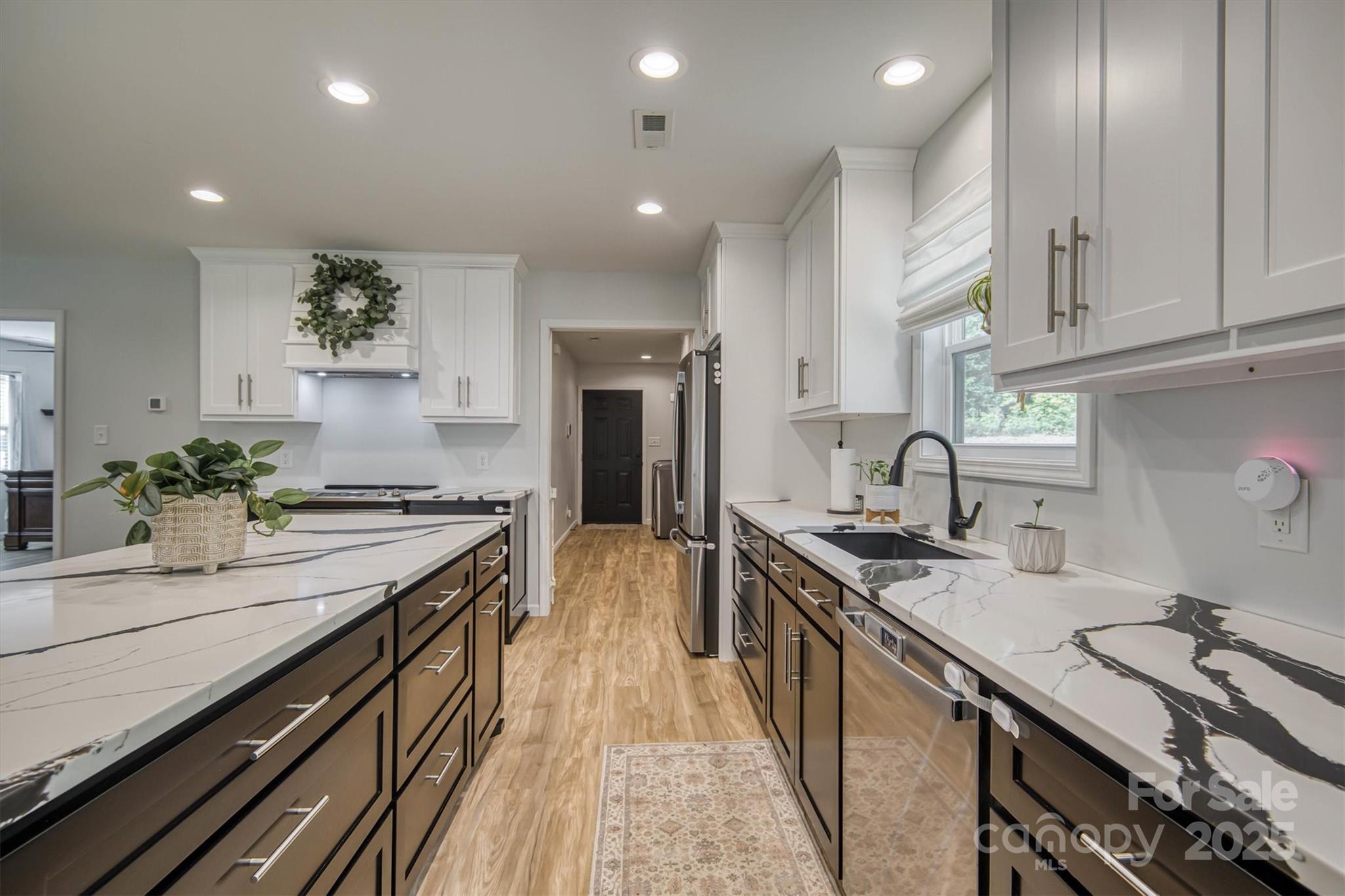 1173 Coffey Road Morganton, NC 28655 - Photo 5 of 26 a kitchen with stainless steel appliances a sink stove and cabinets