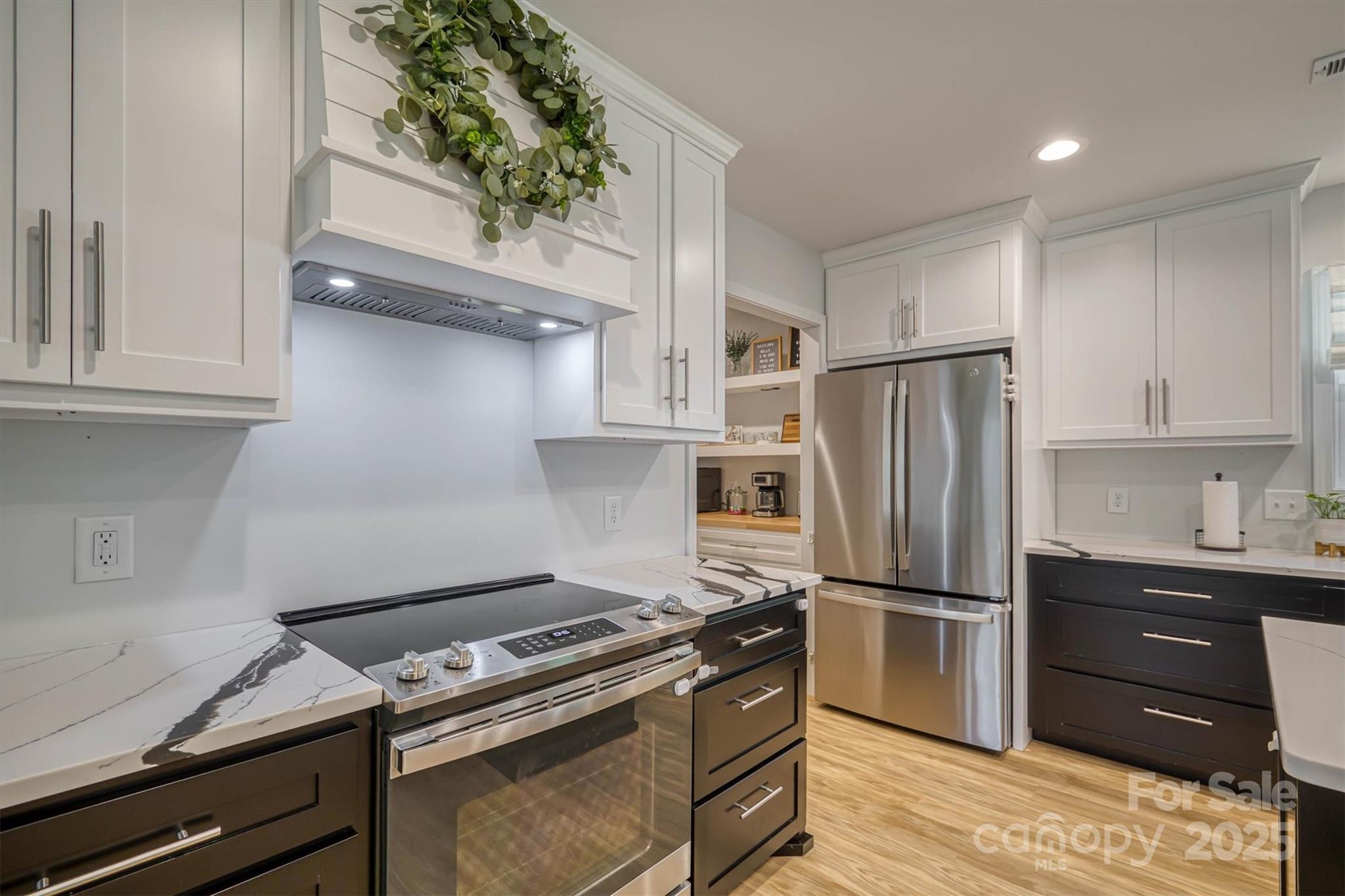 1173 Coffey Road Morganton, NC 28655 - Photo 7 of 26 a kitchen with a refrigerator and a stove