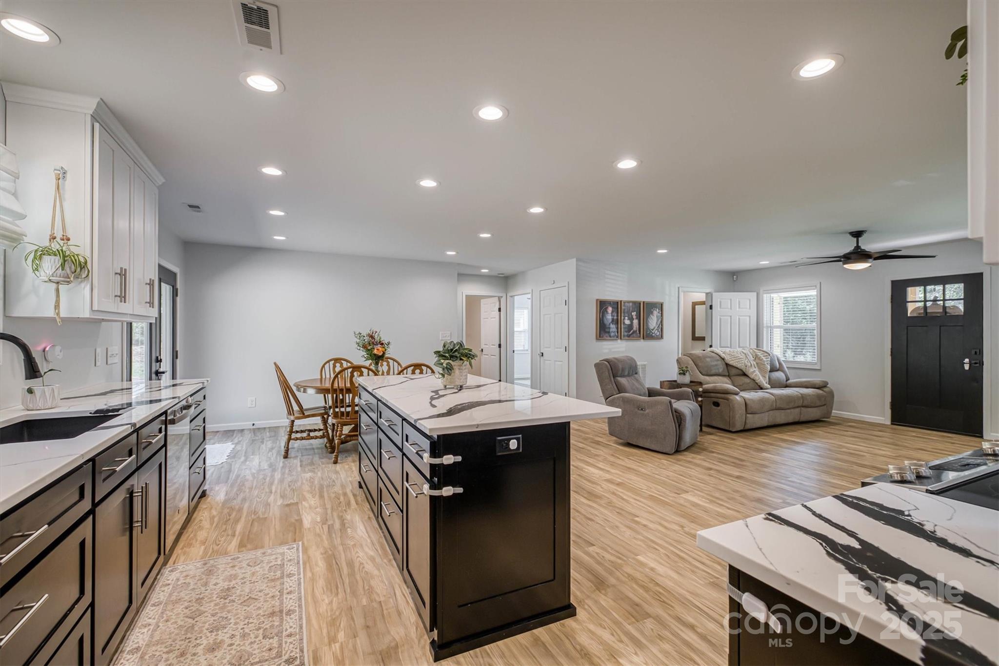 1173 Coffey Road Morganton, NC 28655 - Photo 8 of 26 a living room with furniture a rug kitchen view and a faucet