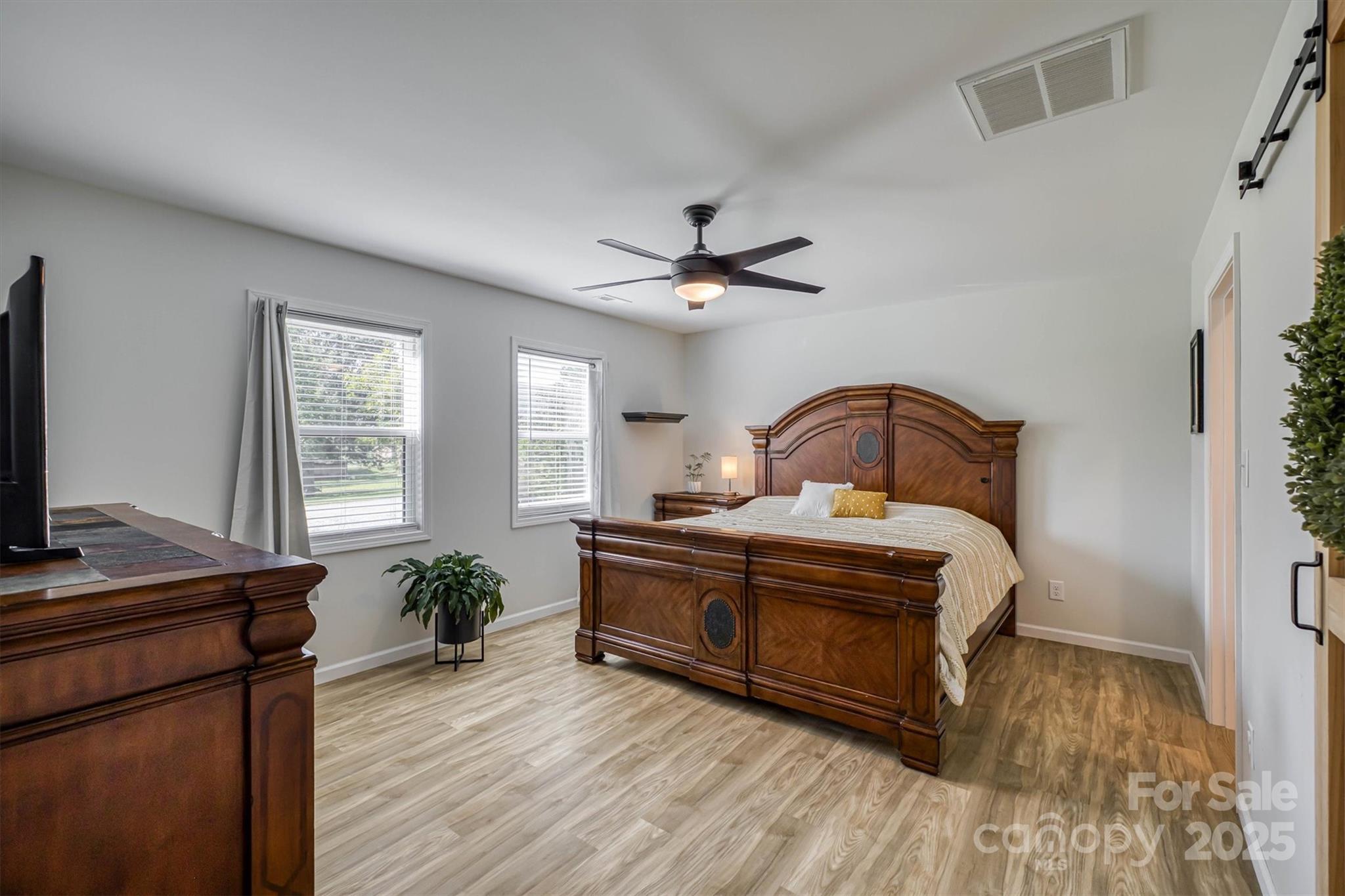 1173 Coffey Road Morganton, NC 28655 - Photo 10 of 26 a bedroom with a bed and a potted plant